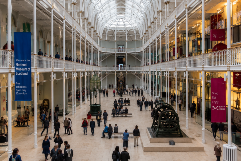 : National Museum of Scotland in Edinburgh UK with grand Victorian architecture, museum exhibits, galleries, and visitors