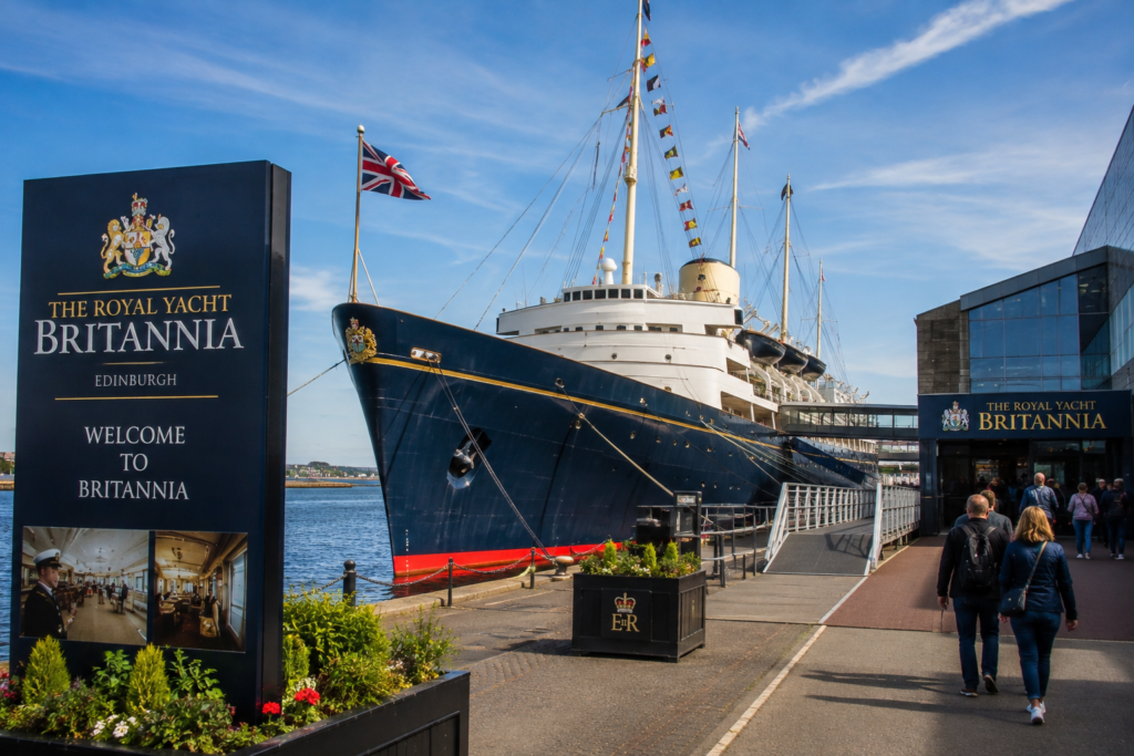 Royal Yacht Britannia in Edinburgh UK with historic ship, Union Jack flags, waterfront, visitors, and scenic harbor views